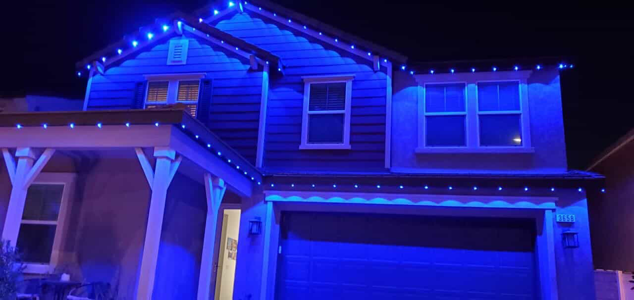Two-story home washed in blue permanent LED lighting