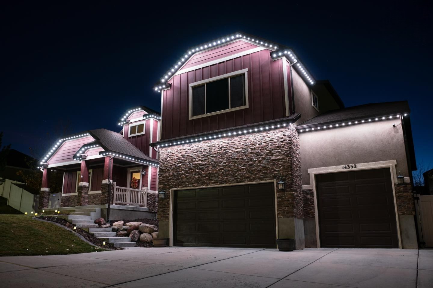 Home at night outlined in warm white permanent eave lighting